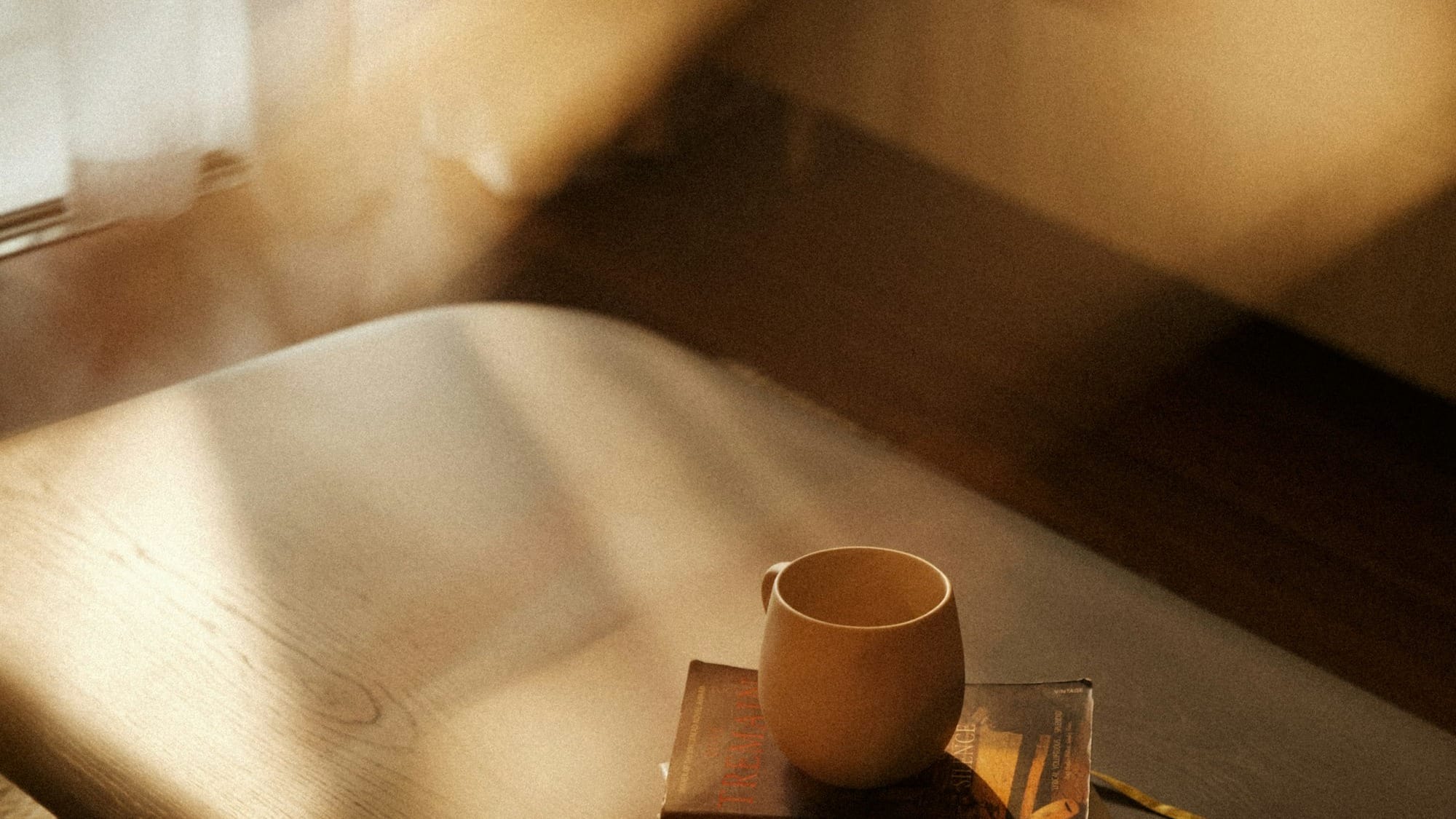A coffee cup sitting on top of a wooden table